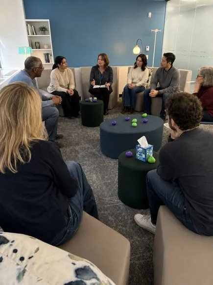 An adult grief support group meeting in a circle