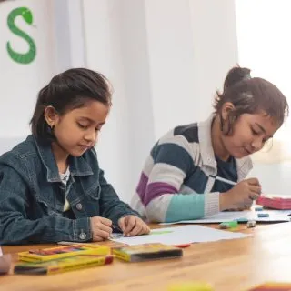 Two students working together at a table